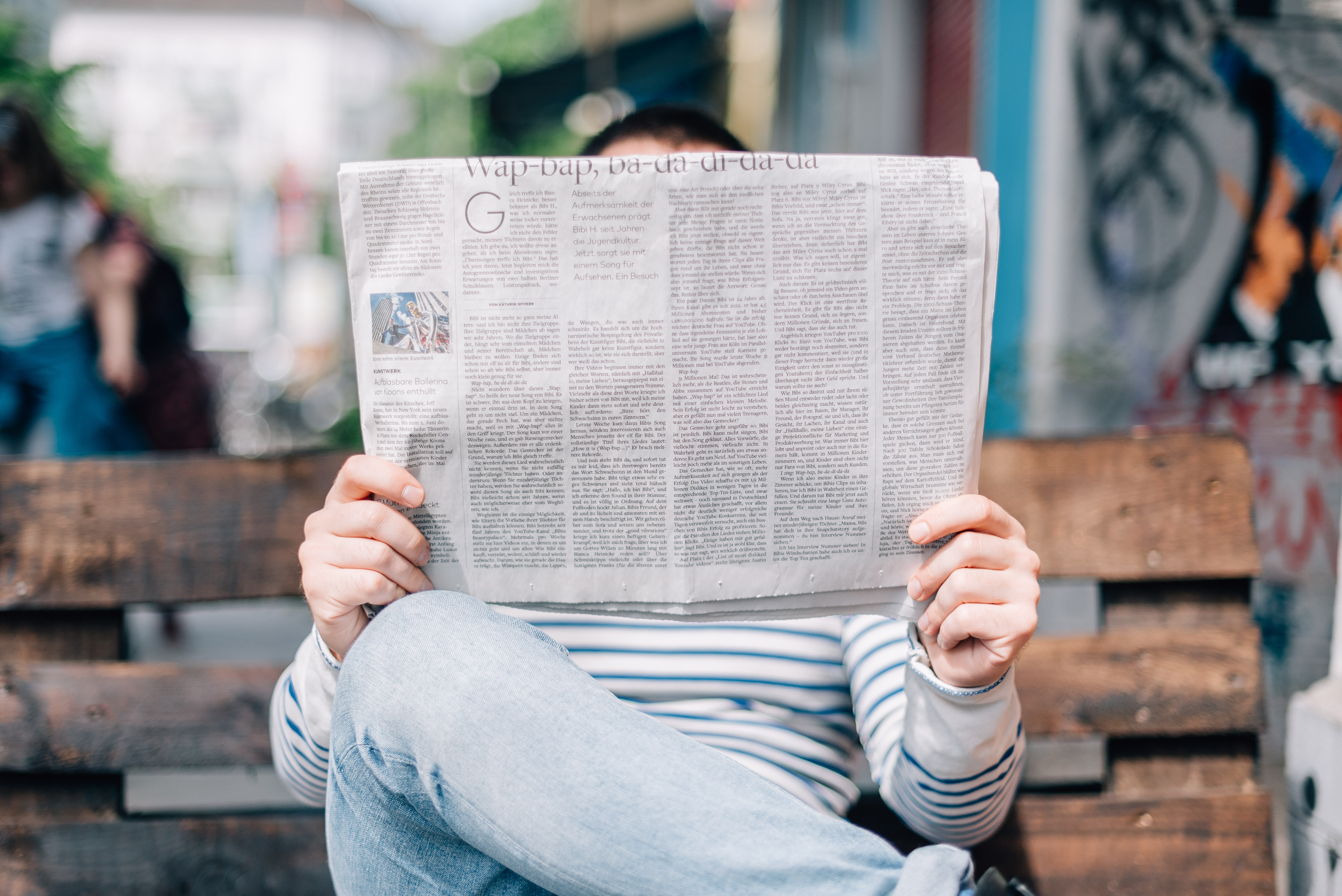 Photo of man reading a newspaper